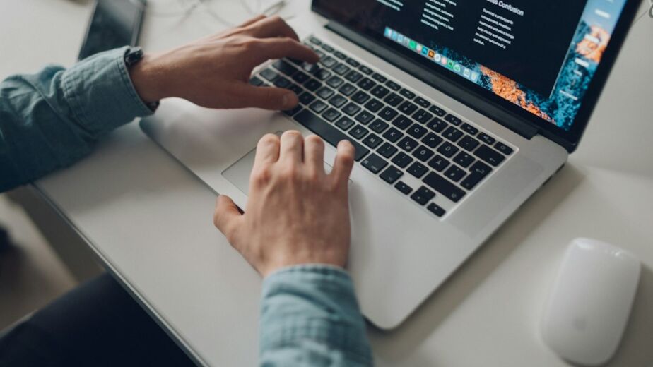 Merchant managing an online store on a laptop