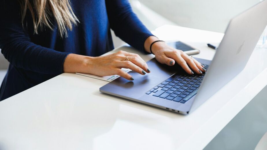 Marketer working on a laptop to build a high-converting landing page